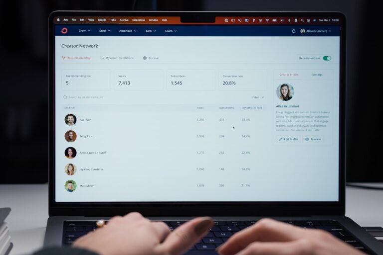 Creator reviewing community platform pricing on a laptop in a modern workspace